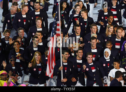 Michael Phelps holds the American flag as he leads the United States in the arena at the Opening Ceremony of the 2016 Rio Summer Olympics begins in Rio de Janeiro, Brazil on August 5, 2016.     Photo by Terry Schmitt/UPI Stock Photo