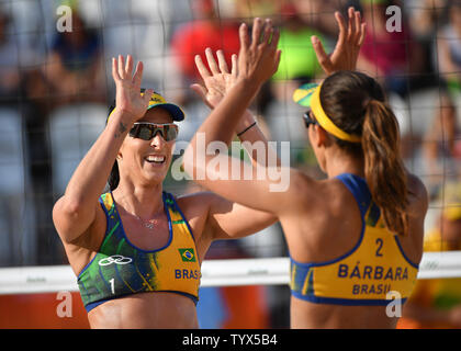 Brazil's Agatha Rippel (L) and Barbara Seixas celebrate after defeating the Czech Republic during their preliminary beach volleyball game in the 2016 Rio Summer Olympics in Rio de Janeiro, Brazil, August 6, 2016. Photo by Kevin Dietsch/UPI Stock Photo