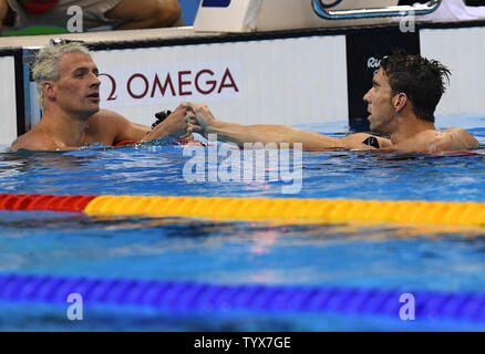 USA's Ryan Lochte (L) and Michael Phelps wait for results in a Men's 200M Individual Medley semifinal at the Olympic Aquatics Stadium at the 2016 Rio Summer Olympics in Rio de Janeiro, Brazil, on August 10, 2016. Photo by Richard Ellis/UPI. Stock Photo