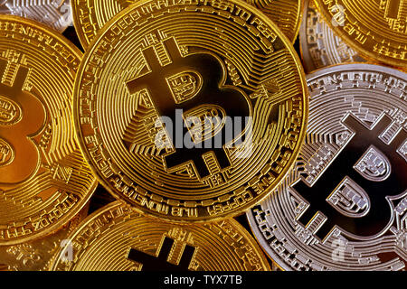 Many golden bitcoins. Cryptocurrency and virtual money concept. Shiny coins with bitcoin symbol Stock Photo