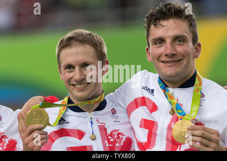 Cyclists Jason Kenny and Philip Hindes of Great Britain show their gold medals following the presentation ceremony for the Men's Team Sprint Finals at the Rio Olympic Velodrome during the 2016 Summer Olympics in Rio de Janeiro, Brazil, on August 11, 2016. Great Britain won with a time of 42.440 setting a new Olympic Record.   Photo by Richard Ellis/UPI Stock Photo