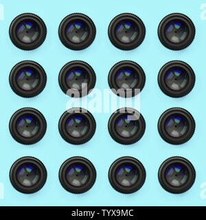 A few camera lenses with a closed aperture lie on texture background of fashion pastel blue color paper in minimal concept. Abstract trendy pattern. Stock Photo