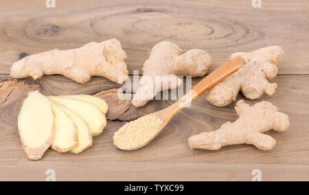 Ginger powder and ginger on wooden table Stock Photo