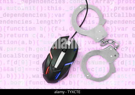 Computer mouse in a police color is chained in handcuffs on the ...