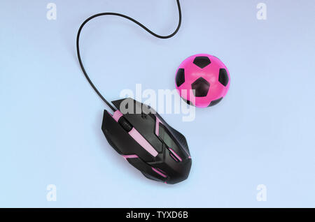 Soccer ball with computer mouse on blue background. Concept of videogames, eSports, sports betting and online gambling Stock Photo