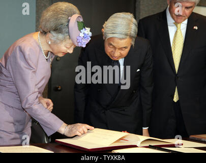 Empress Michiko, Emperor Akihito of Japan, and Canadian Foreign Affairs Minister Lawrence Cannon peruse National Library of Canada archives recording the Emperor's first visit to Canada as Crown Prince in 1953 at the Pearson building in Ottawa on July 8, 2009. The Imperial Couple is visiting Canada to mark the 80th anniversary of diplomatic relations between Canada and Japan.   (UPI Photo/Grace Chiu)