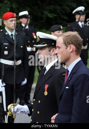 His Royal Highness, Prince William, the Duke of Cambridge, is escorted by Lieutenant-Commander Andre Savard to inspect the Canadian Forces honour guard at Rideau Hall in Ottawa on June 30, 2011. The Royal Couple will reside at Rideau Hall for the first two nights of their nine-day tour of Canada. (UPI Photo/Grace Chiu) Stock Photo