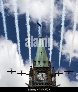 The Snowbirds Canadian Air Force aerobatics squad performs their annual flyover formation over the Peace Tower as Their Royal Highnesses Prince William and Catherine, The Duke and Duchess of Cambridge celebrate Canada Day on Parliament Hill in Ottawa on July 1, 2011.  (UPI Photo/Grace Chiu) Stock Photo