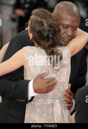 Actress Marion Cotillard receives a hug from actor Forest Whitaker while arriving for a screening of their new film 'Mary' at the 31st annual American Film Festival in Deauville, France on September 9, 2005.         (UPI Photo/David Silpa) Stock Photo