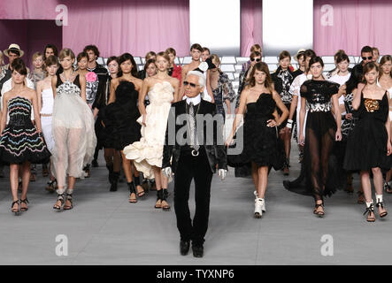 German fashion designer Karl Lagerfeld acknowledges applause following the presentation of his Chanel spring/summer 2006 ready-to-wear collection in Paris on October 7, 2005.    (UPI Photo/William Alix) Stock Photo