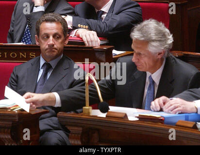 French Interior Minister Nicolas Sarkozy glances at Prime Minister Dominique de Villepin during a questino and answer session at the National Assembly in Paris May 2, 2006. The embattled premier today ruled out resigning over allegations that he tried to smear Sarkozy, his chief rival for the presidency.  (UPI Photo/Eco Clement) Stock Photo