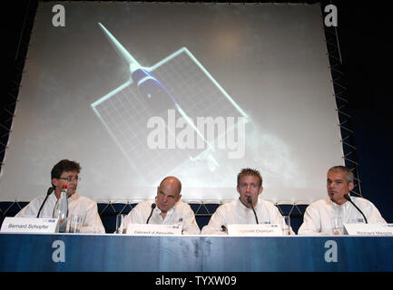 The image of the Planet Solar trimaran is displayed on a giant screen at the start of a news conference to announce the first round-the-world sea voyage powered by solar energy, in Paris on November 28, 2006. The trimaran, equipped with silent and non-polluting motorization, will be co-captained by French sailor Gerard d'Aboville (2L), famed for his solo rowing across the Atlantic and the Pacific Oceans, and Swiss project founder Raphael Domjan (2R). (UPI Photo/Eco Clement) Stock Photo