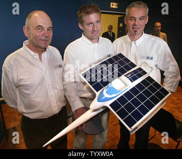 (L to R) French sailor Gerard d'Aboville, famed for his solo rowing across the Atlantic and the Pacific Oceans, Swiss project founder Raphael Domjan and project designer and builder Richard Mespl, hold a model of the Planet Solar trimaran which is set to circumnavigate the globe powered only by solar energy, in Paris on November 28, 2006.  The trimaran, equipped with silent and non-polluting motorization, will be co-captained by d'Aboville and Domjan.   (UPI Photo/Eco Clement) Stock Photo