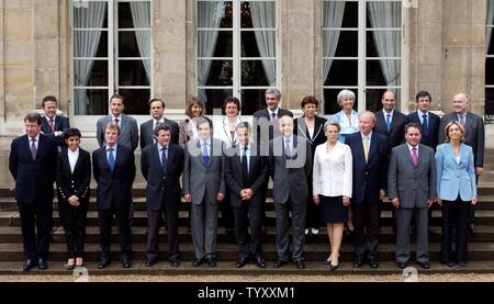 French President Nicolas Sarkozy, foreground center, poses for a group photo along with members of his government after the first Cabinet meeting, Friday, May 18, 2007 at the Elysee Palace in Paris. Ministers are, foreground, from left : Education Minister Xavier Darcos, Justice Minister Rachida Dati, Foreign Minister Bernard Kouchner, Finance Minister Jean-Louis Borloo, Prime Minister Francois Fillon, President Nicolas Sarkozy, Environment Minister Alain Juppe, Interior Minister Michele Alliot-Marie, Minister of Immigration, Integration and National Identity, Brice Hortefeux, Labor Minister X Stock Photo