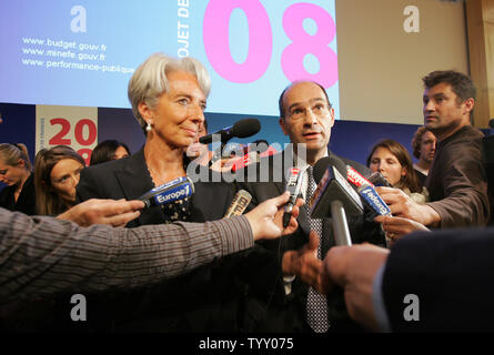 French Economy and Finance Minister Christine Lagarde (L) and Budget Minister Eric Woerth are mobbed by journalists at the end of a news conference to unveil the country's 2008 budget, in Paris, September 26, 2007. The two ministers of French President Nicolas Sarkozy's government unveiled today its first budget since taking office, with state spending under scrutiny after the prime minister warned that France was bankrupt. (UPI Photo/Eco Clement) Stock Photo