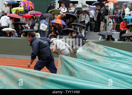 Workers pour a cover on one of Roland Garros' court as continued downpours interrupted the matches on the third day of the French Open tennis tournament at Roland Garros Paris, May 27, 2008.   (UPI Photo/Eco Clement) Stock Photo