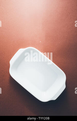 Empty rectangular White baking dish over a brown background, top view Stock Photo