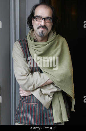 Afghan author Atiq Rahimi poses for photographers after he was awarded France's most prestigious literary prize, the 105-year-old Prix Goncourt, in Paris, November 10, 2008. The author who seeked asylum in France after the Soviet-invasion, wrote 'Syngue Sabour'' or 'Stone of Patience,'' the story of a woman in a country resembling Afghanistan whose husband has been wounded in battle and now lies as paralyzed as a stone. (UPI Photo/Eco Clement) Stock Photo