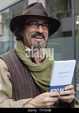 Afghan author Atiq Rahimi poses for photographers after he was awarded France's most prestigious literary prize, the 105-year-old Prix Goncourt, in Paris, November 10, 2008. The author who seeked asylum in France after the Soviet-invasion, wrote 'Syngue Sabour'' or 'Stone of Patience,'' the story of a woman in a country resembling Afghanistan whose husband has been wounded in battle and now lies as paralyzed as a stone. (UPI Photo/Eco Clement) Stock Photo