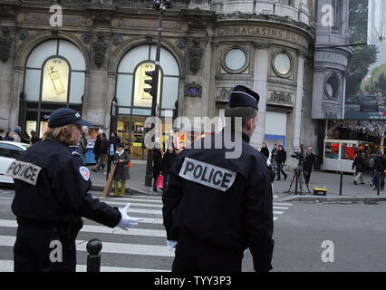 French police stand in front of Le Printemps department store in Paris, on December 16, 2008, as business slowly goes back to normal following a bomb scare. Le Printemps was cordoned off and evacuated after a group calling itself the Afghan Revolutionary Front warned they had placed 'several bombs' in the store. (UPI Photo/Eco Clement) Stock Photo