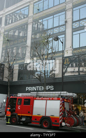 A French firefighter jumps into the driver's seat in front of Le Printemps department stores in Paris, December 16, 2008, as business slowly goes back to normal following a bomb scare. Le Printemps was cordoned off and evacuated after a group, calling itself the Afghan Revolutionary Front, warned they had placed 'several bombs' in the store. (UPI Photo/Eco Clement) Stock Photo