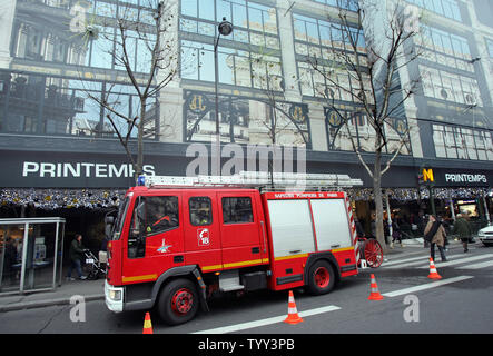 A fire truck sits in front of Le Printemps department store in Paris, on December 16, 2008, as business slowly goes back to normal following a bomb scare. Le Printemps was cordoned off and evacuated after a group calling itself the Afghan Revolutionary Front warned they had placed 'several bombs' in the store. (UPI Photo/Eco Clement) Stock Photo