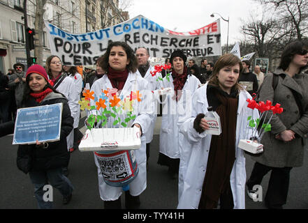 French university students and researchers carry flowers as they reenact the slow death of university studies and research during a protest in Paris, February 26, 2009 in Paris. Thousands took to the streets of the capital to demonstrate against French government  education reforms.  (UPI Photo/Eco Clement) Stock Photo