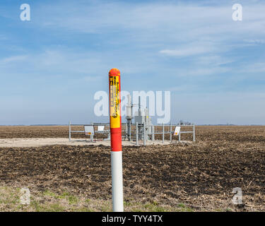 Underground Natural gas pipeline warning sign. Energy infrastructure security, safety and underground utility concept. Stock Photo