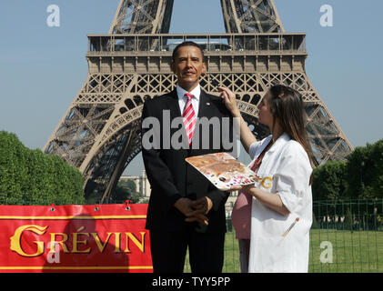 A musem make-up artist puts the finishing touches to US President Barack Obama's wax figure as it is unveiled in front of the Eiffel Tower in Paris, June 29, 2009. The figure is to be put on display at the capital's famed Grevin wax museum, to join other historical figures. (UPI Photo/Eco Clement) Stock Photo