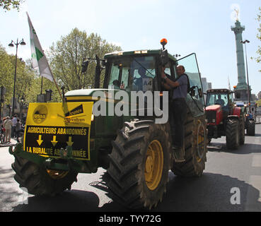 French grain farmers drive their tractors through the Place de la Bastille during a protest in Paris on April 27, 2010.  The demonstration, to protest falling revenues and to demand a return to increased EU regulation of their markets, brought Paris traffic to a halt throughout various parts of the city.   UPI/David Silpa Stock Photo