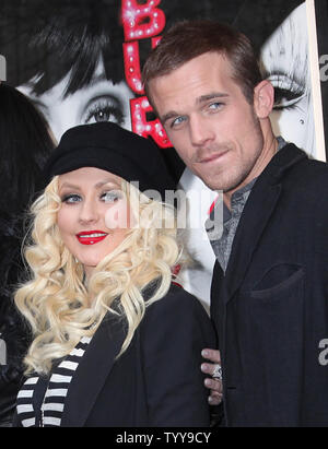 Christina Aguilera (L) and Cam Gigandet arrive at a photocall for the film 'Burlesque' at the Crazy Horse Cabaret in Paris on December 15, 2010.     UPI/David Silpa Stock Photo