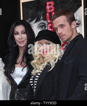 Cher (L), Christina Aguilera (C) and Cam Gigandet arrive at a photocall for the film 'Burlesque' at the Crazy Horse Cabaret in Paris on December 15, 2010.     UPI/David Silpa Stock Photo