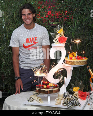 Spaniard Rafael Nadal receives a birthday cake on his 25th