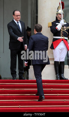 France's outgoing president Francois Hollande (L) greets newly elected president Emmanuel Macron on the steps of the Elysee Palace in Paris on 14 May 2017. Macron was inaugurated today after a handover ceremony with Hollande. Photo by Maya Vidon-White/UPI Stock Photo