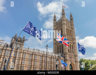 London / UK - June 26th 2019 - European Union and Union Jack flags waving outside UK Parliament, held up by Pro-EU anti-Brexit protesters Stock Photo