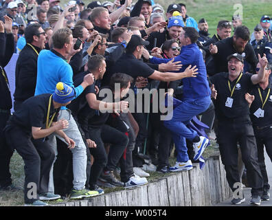 Rory McIlroy celebrates with green keepers after Team Europe clinched the Ryder Cup at Le Golf National in Guyancourt near Paris on September 30, 2018. Team Europe defeated Team USA 17.5 to 10.5 to hand the Americans their sixth straight loss on foreign soil.  Photo by David Silpa/UPI Stock Photo