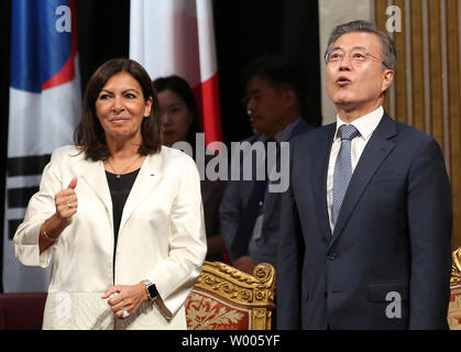 South Korean President Moon Jae-in (R), flanked by Paris Mayor Anne Hidalgo, arrives at City Hall for an official welcome ceremony in Paris on October 16, 2018. The South Korean president is in Paris on a four-day official state visit.   Photo by David Silpa/UPI Stock Photo