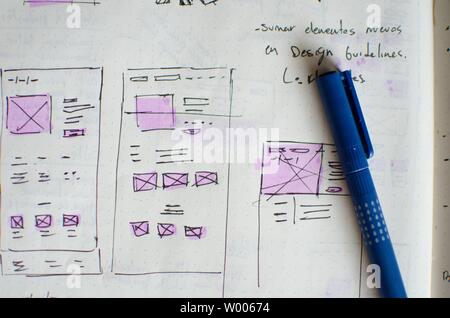 Closeup of UI/UX draft sheet with highlighted areas with a magic marker ...
