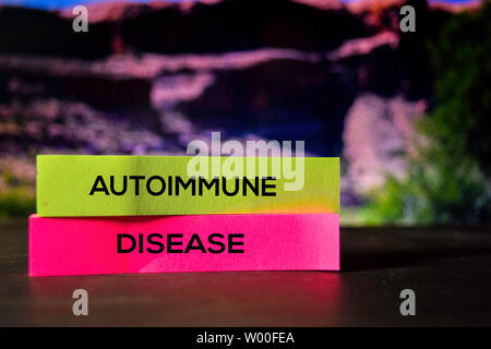 Autoimmune Disease on the sticky notes with bokeh background Stock Photo