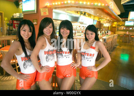 Chinese Hooters waitresses pose for a photographs in the first Hooters