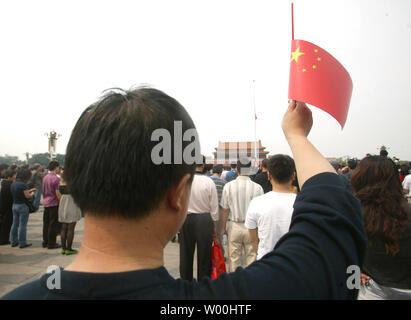 Thousands of Chinese flock to Tienanmen Square to attend the first day of a three-day state-sanctioned mourning of the tremendous loss of life in the earthquakes that hit Sichuan and other provinces, in Beijing on May 19, 2008.  From Beijing to the devastated southwest, China came to a standstill Monday to mourn its earthquake victims as the number of dead, missing or buried soared past 71,000.  Air sirens wailed across the country as most motorists stopped and blared their horns, bringing an eerie halt to China's usually bustling big cities for three minutes from 2:28 pm, the moment the quake Stock Photo