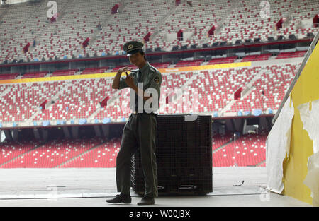 A security guard patrols the inside grounds of  the National Stadium, also known as the Bird's Nest,  just weeks before the start of the Olympic games, in Beijing July 19, 2008.  (UPI Photo/Stephen Shaver) Stock Photo