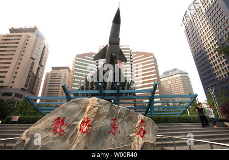 Chinese walk past a Chinese fighter jet on display in front of a main military aviation ministry complex in downtown Beijing on June 06, 2010.  The United States appealed to China on Saturday to restore military ties despite discord over U.S. arms sales to Taiwan and said it was considering options beyond the United Nations to punish North Korea over the sinking of a South Korean naval ship.     UPI/Stephen Shaver Stock Photo