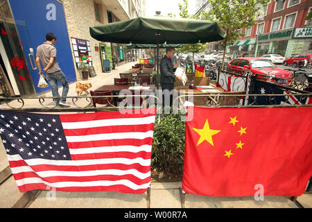American and Chinese national flags are hung around a restaurant's patio to attract both foreign and Chinese customers in Beijing on June 29, 2010.  U.S. Federal Reserve Chairman Ben Bernanke said earlier this month that China recognized it has a 'codependency' with the United States and he welcomed closer ties.       UPI/Stephen Shaver Stock Photo