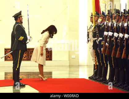 Argentina's President Cristina Kirchner de Fernandez bows to a military honor guard during a welcoming ceremony at the Great Hall of the People in Beijing on July 13, 2010.  China and Argentina agreed on contracts for railway projects in the South American country totaling 10 billion dollars.    UPI/Stephen Shaver Stock Photo