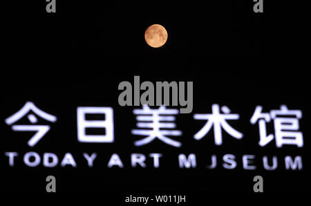 The start of a rare 'blue moon,' which is red due to the pollution in the atmosphere, rises over Beijing on August 30, 2012.  Called 'blue' due the rarity of it, the 'blue moon' occurs when there's a second full moon in one calendar month, with the next one not happening until July 2015.  U.S. astronaut Neil Armstrong's family has suggested paying tribute to the first man on the moon by looking up at the moon and giving the astronaut a wink.    UPI/Stephen Shaver Stock Photo