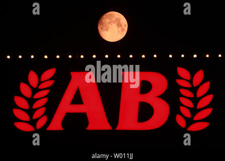 The start of a rare 'blue moon,' which is red due to the pollution in the atmosphere, rises over the Asia Bank's headquarter's in Beijing on August 30, 2012.  Called 'blue' due the rarity of it, the 'blue moon' occurs when there's a second full moon in one calendar month, with the next one not happening until July 2015.  U.S. astronaut Neil Armstrong's family has suggested paying tribute to the first man on the moon by looking up at the moon and giving the astronaut a wink.    UPI/Stephen Shaver Stock Photo