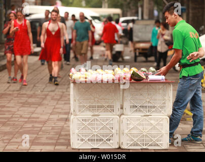 Foreigners and Chinese, both men and women, wear red dresses while running  through the streets of