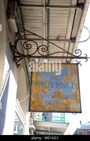 A vintage sign hangs from a closed up shop in the French Quarter of New Orleans, Louisiana Stock Photo