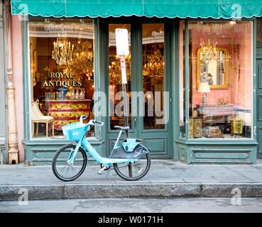 A bicycle sits outside an antique shop in New Orleans, Louisiana Stock Photo